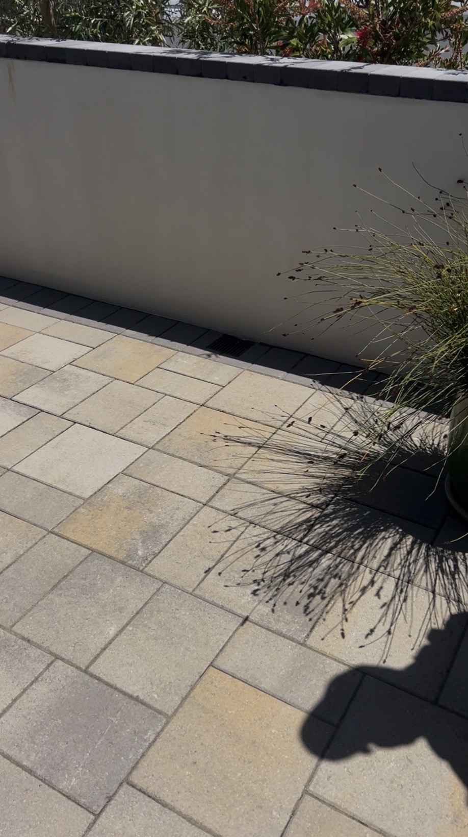 White retaining wall with finished paver patio